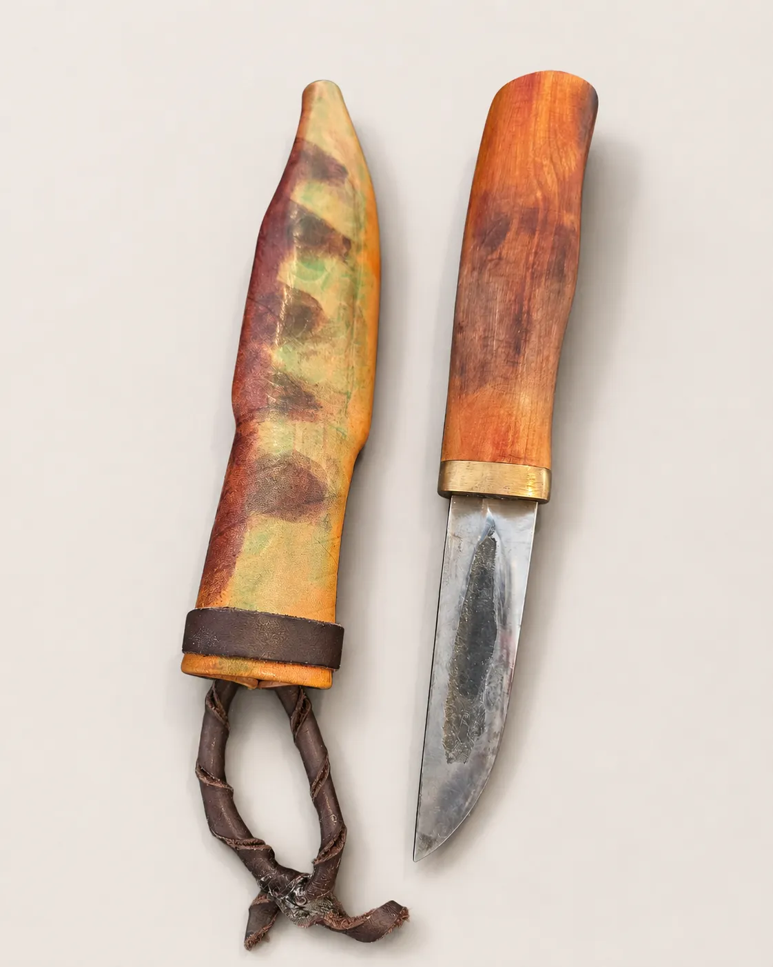 A Studio Satori puukko with its leather sheath